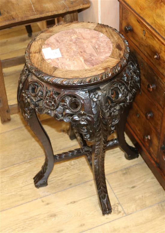 An early 20th century Chinese hardwood vase stand, with marble inset top, H.60cm